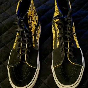 Vans Black and Yellow High-Top Sneakers with Bold Accents